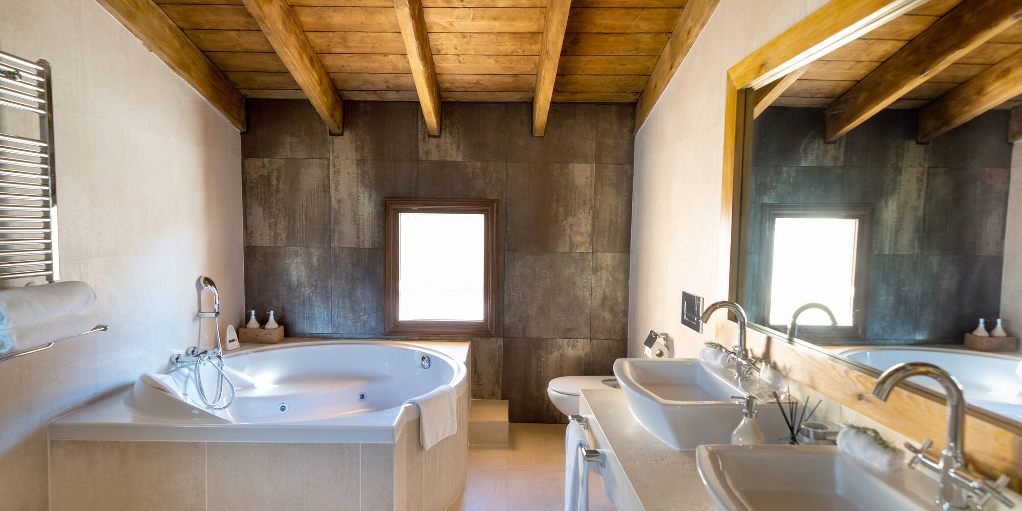 a bathroom with a tub and sinks