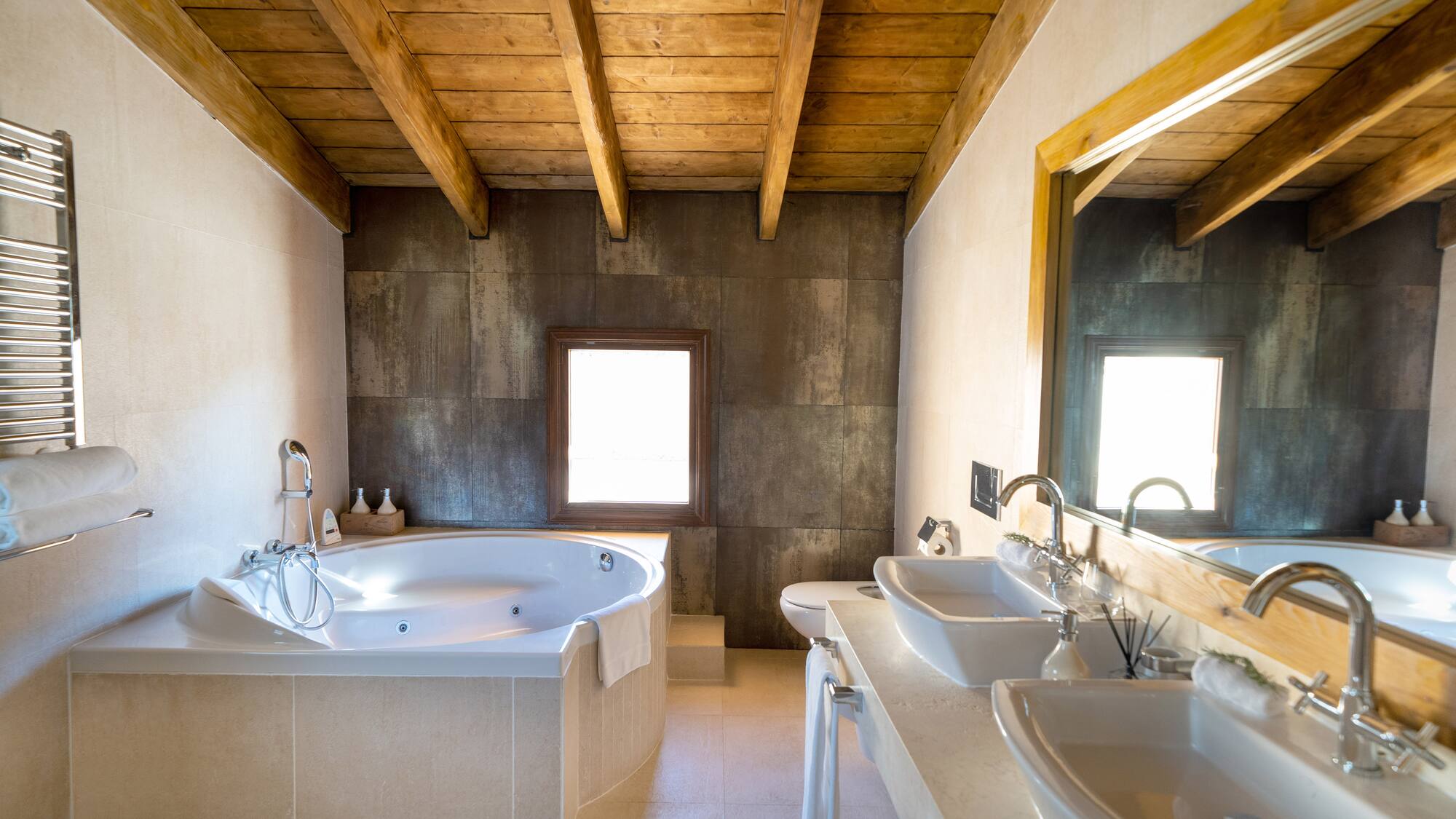 a bathroom with a tub and sinks