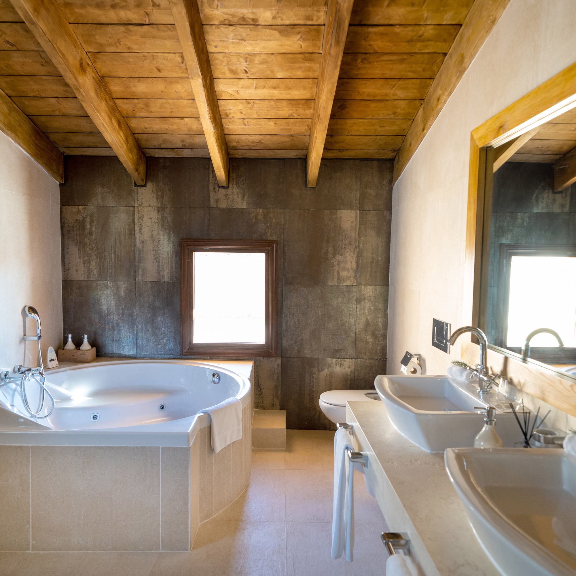 a bathroom with a tub and sinks
