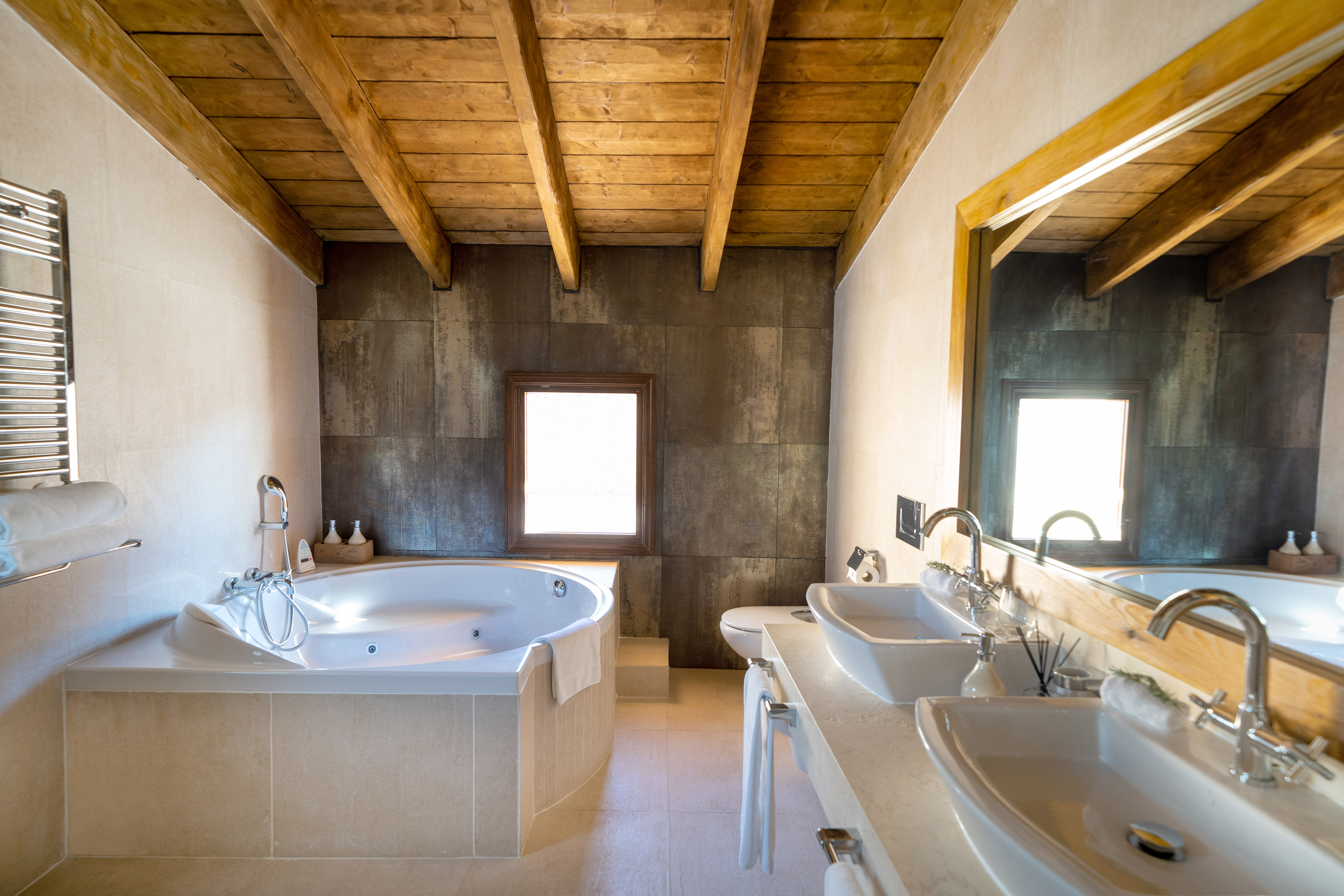 a bathroom with a tub and sinks