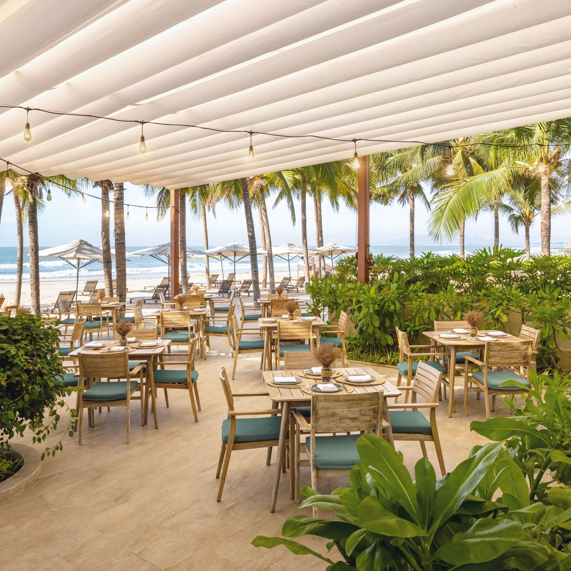 a restaurant with tables and chairs on a beach