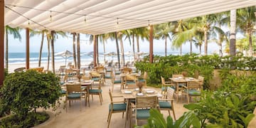 a restaurant with tables and chairs on a beach
