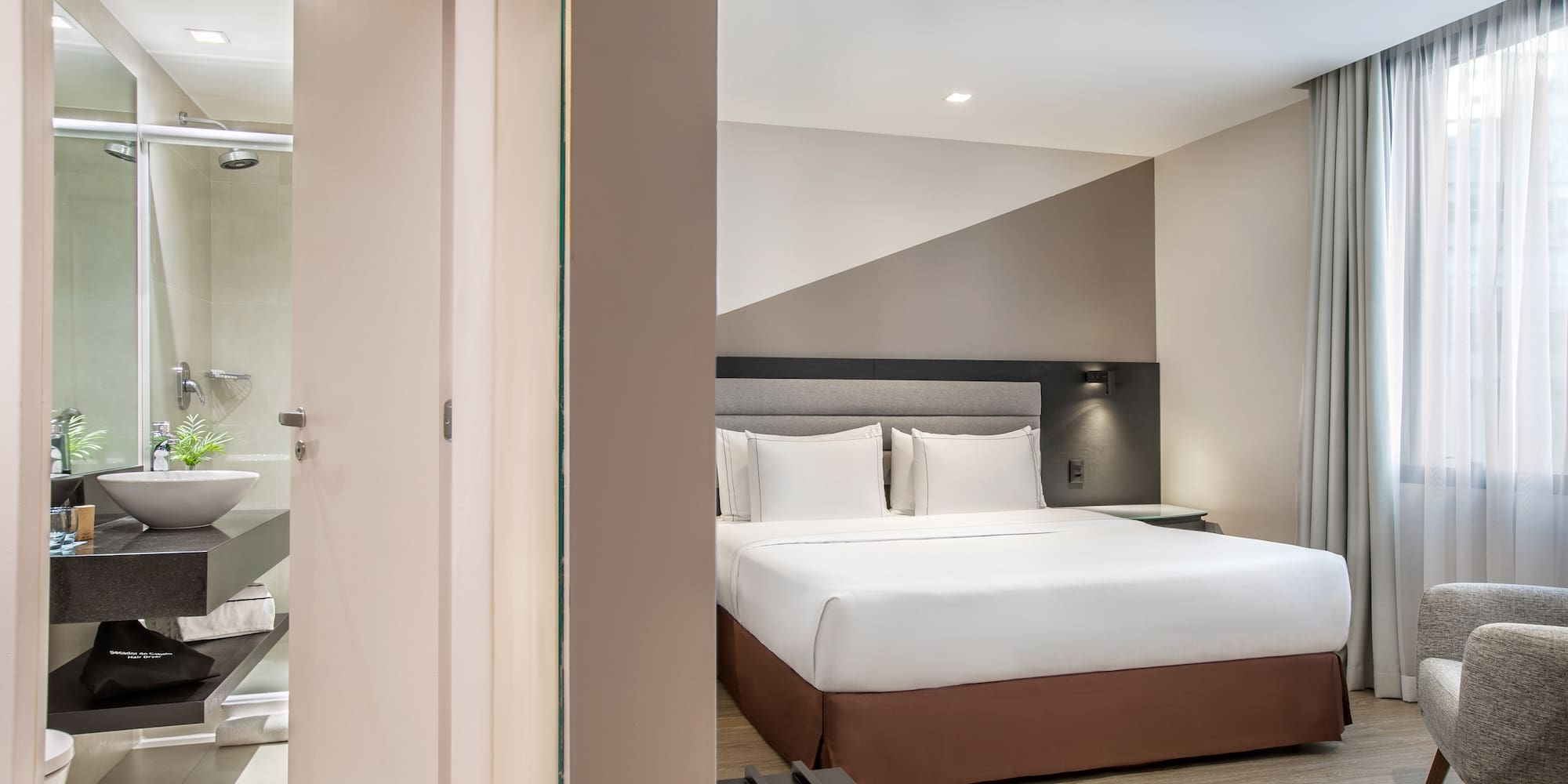 a bedroom with a bed and a shower