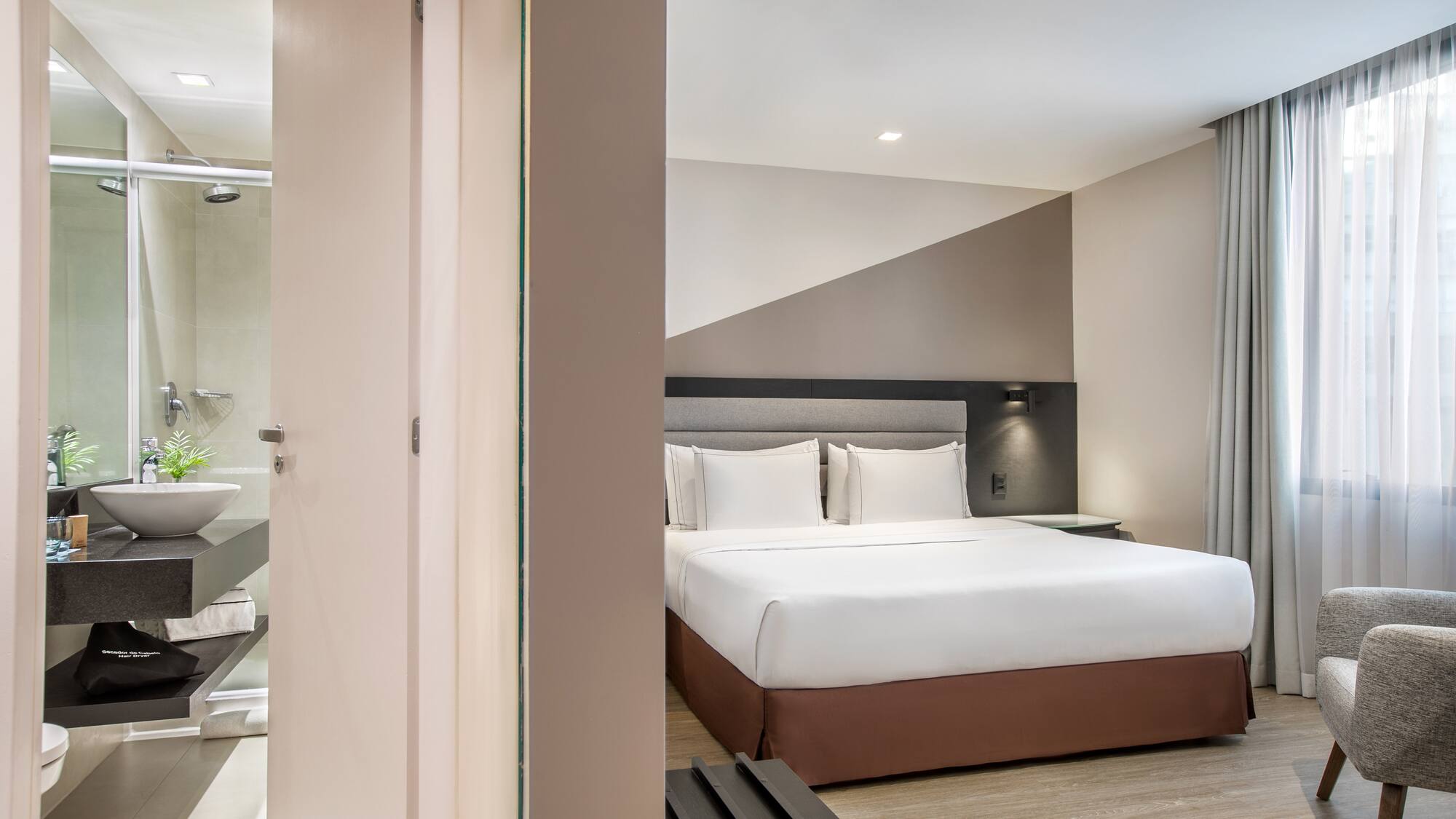 a bedroom with a bed and a shower