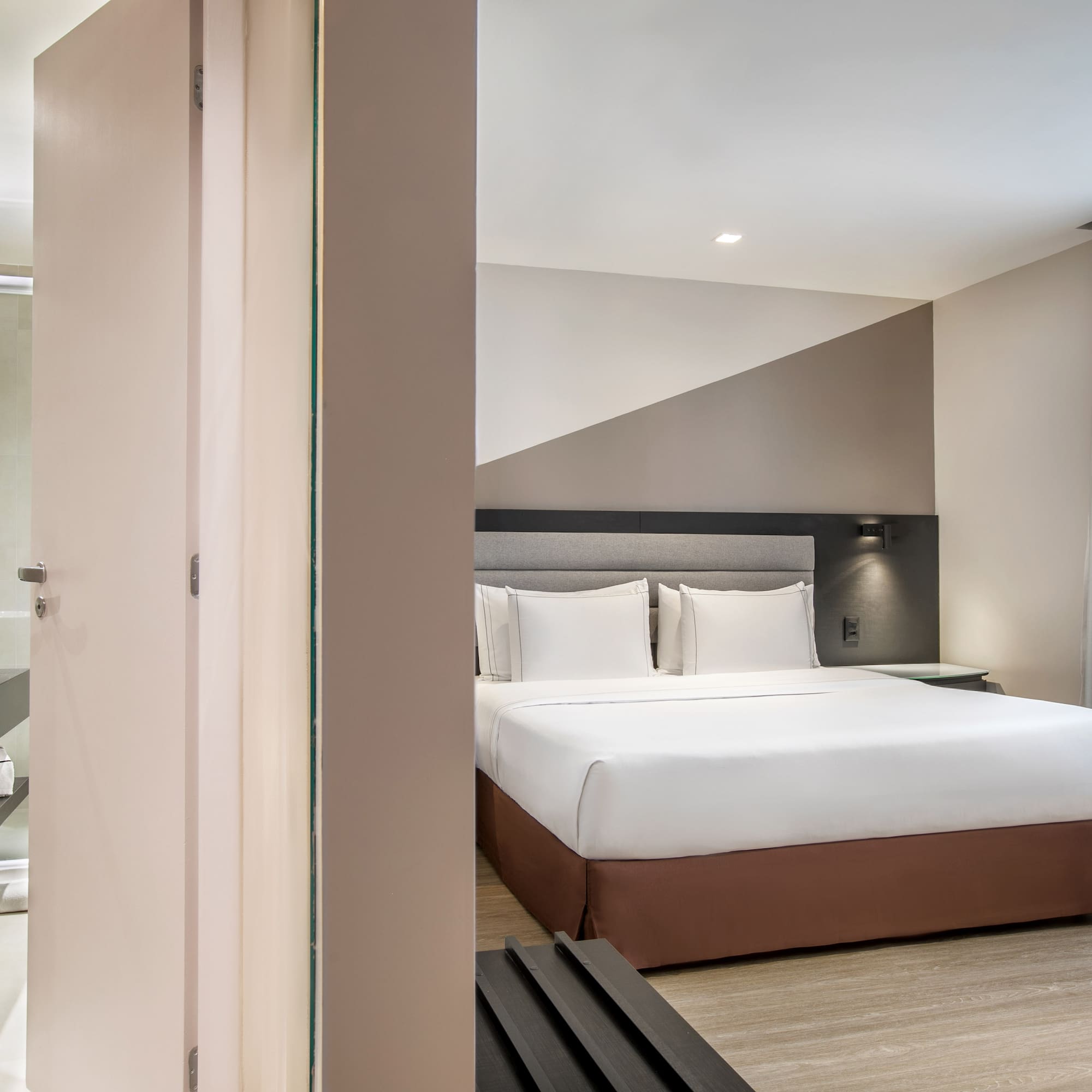 a bedroom with a bed and a shower