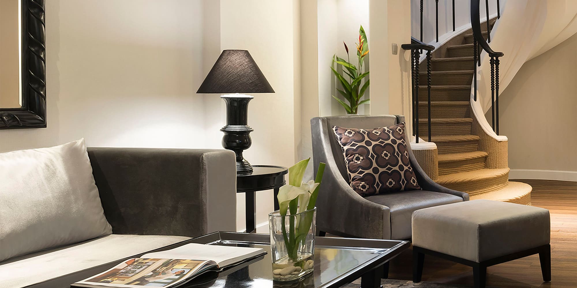 a living room with a spiral staircase and a couch