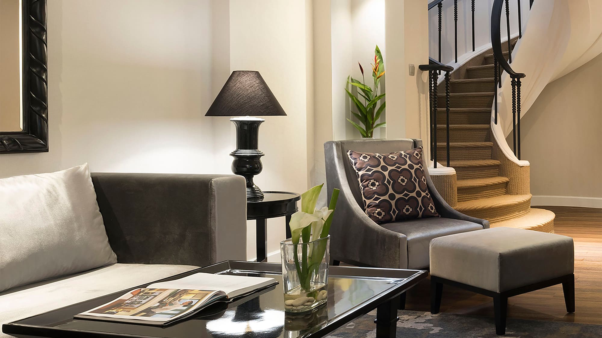 a living room with a spiral staircase and a couch