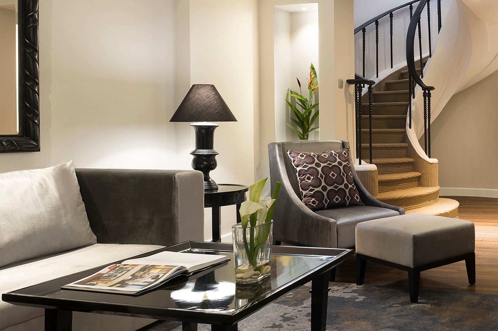 a living room with a spiral staircase and a couch