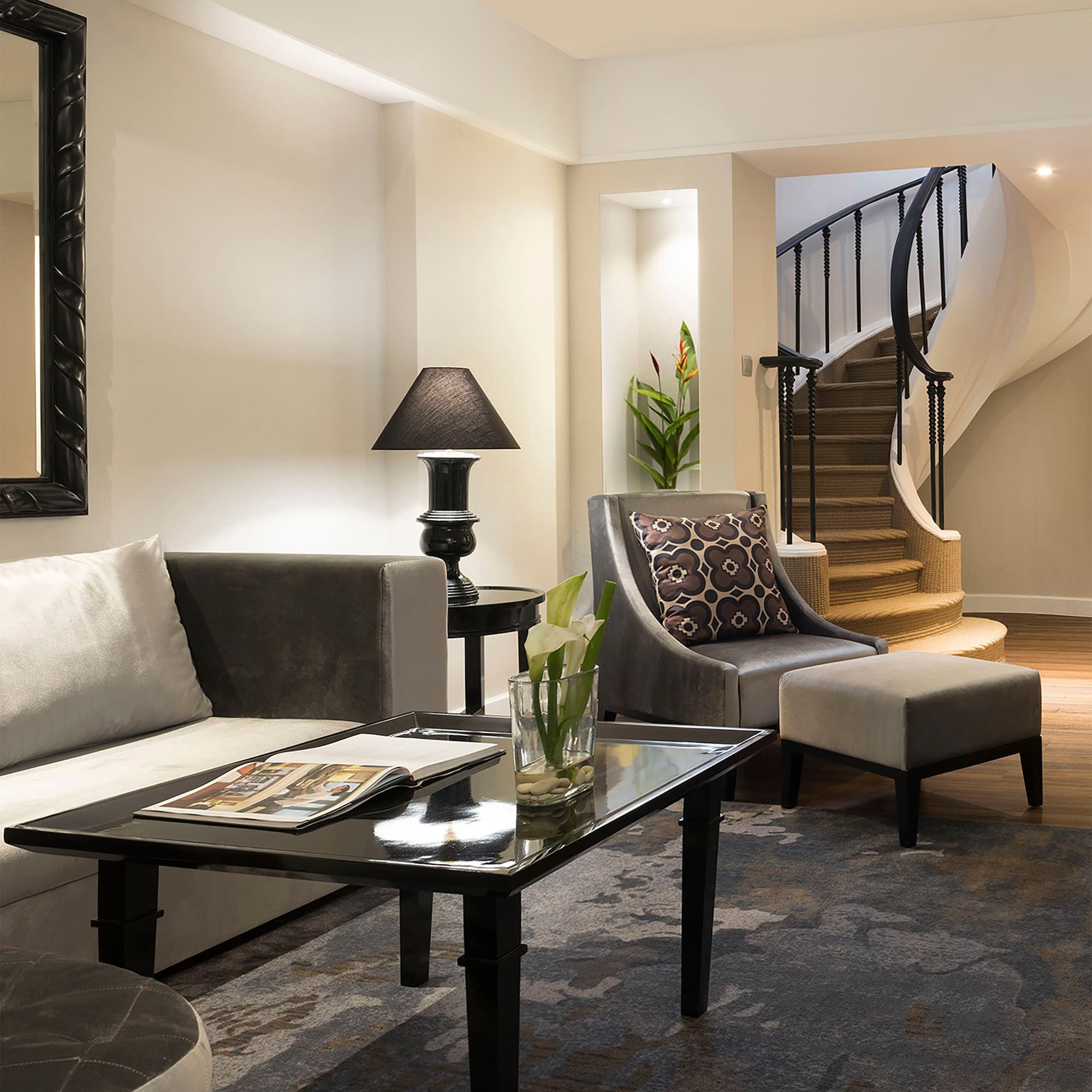a living room with a spiral staircase and a couch
