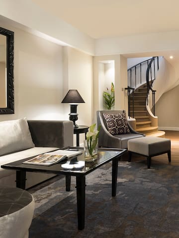 a living room with a spiral staircase and a couch