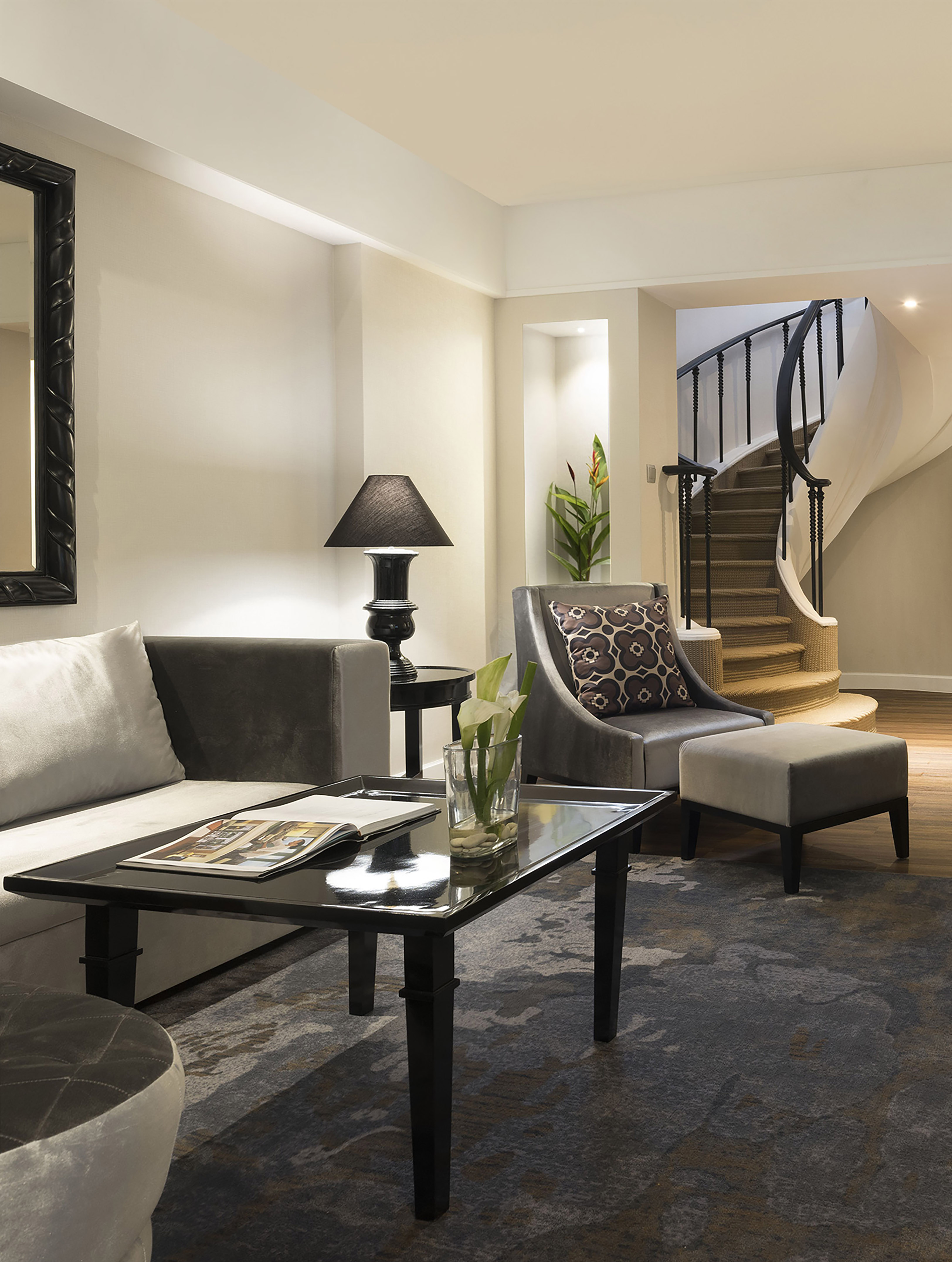 a living room with a spiral staircase and a couch