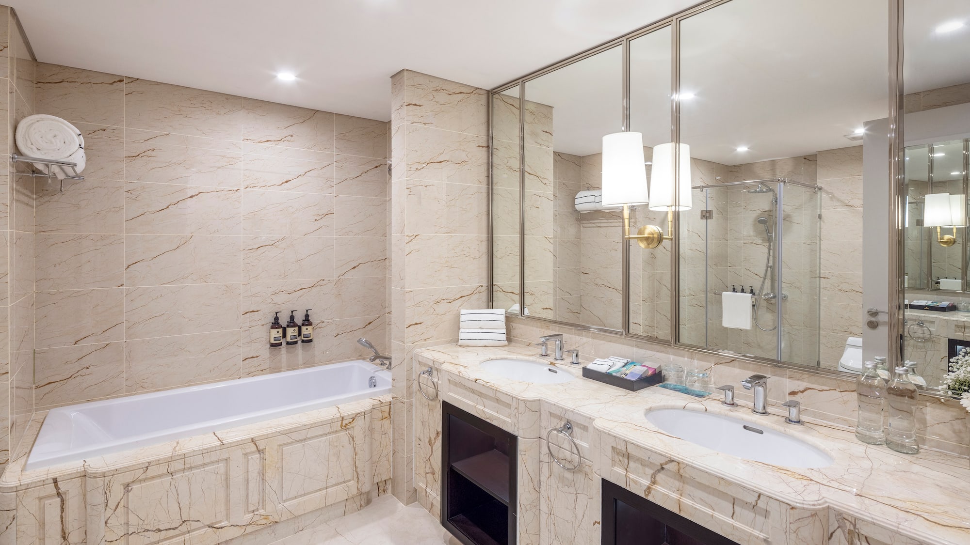 a bathroom with marble countertops and a tub