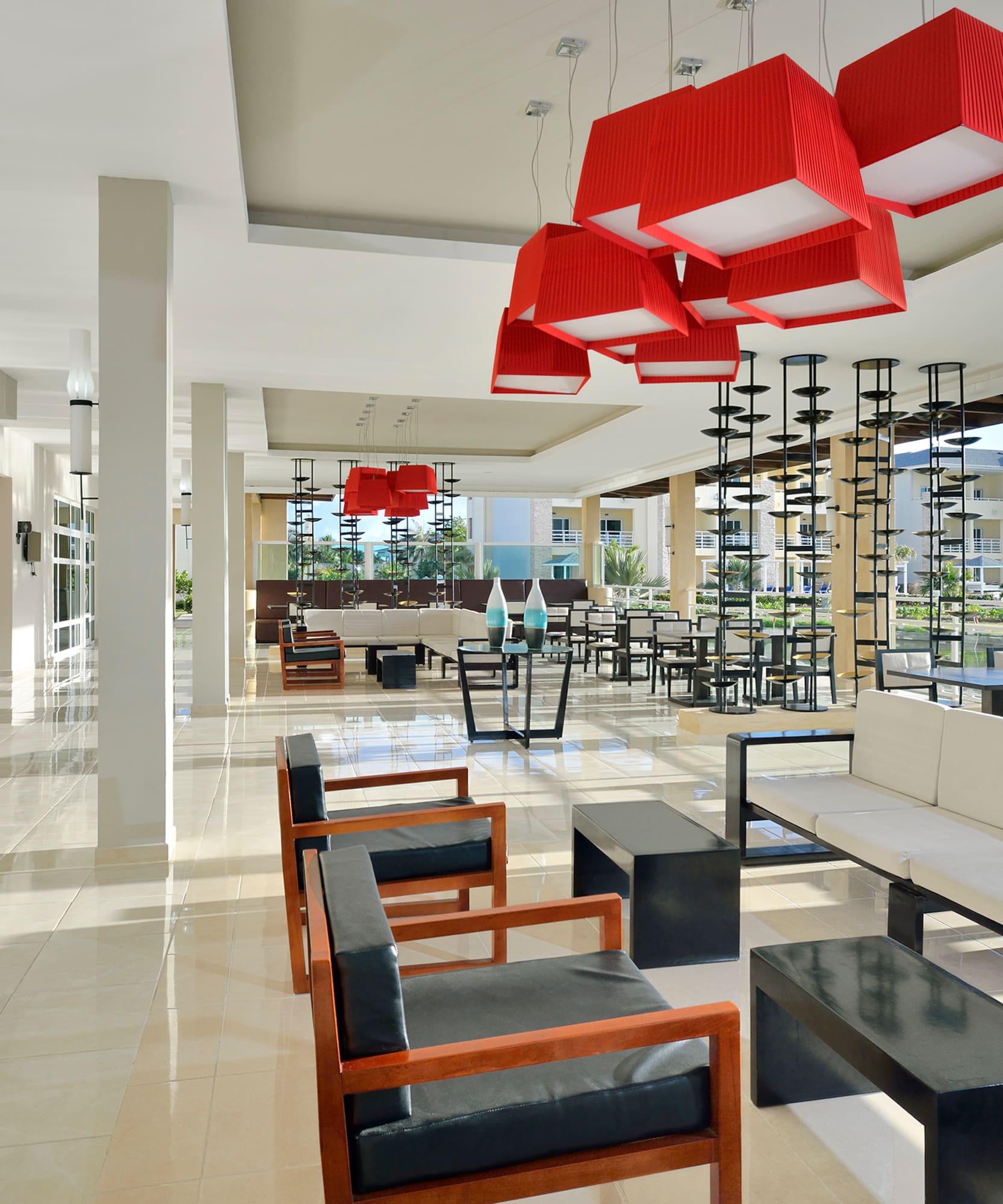 a room with chairs and a red chandelier