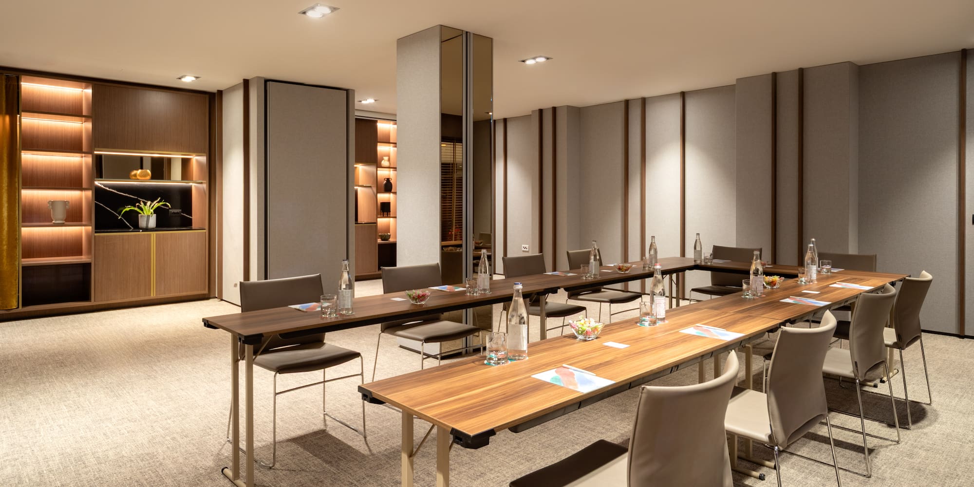 a room with a long table and chairs