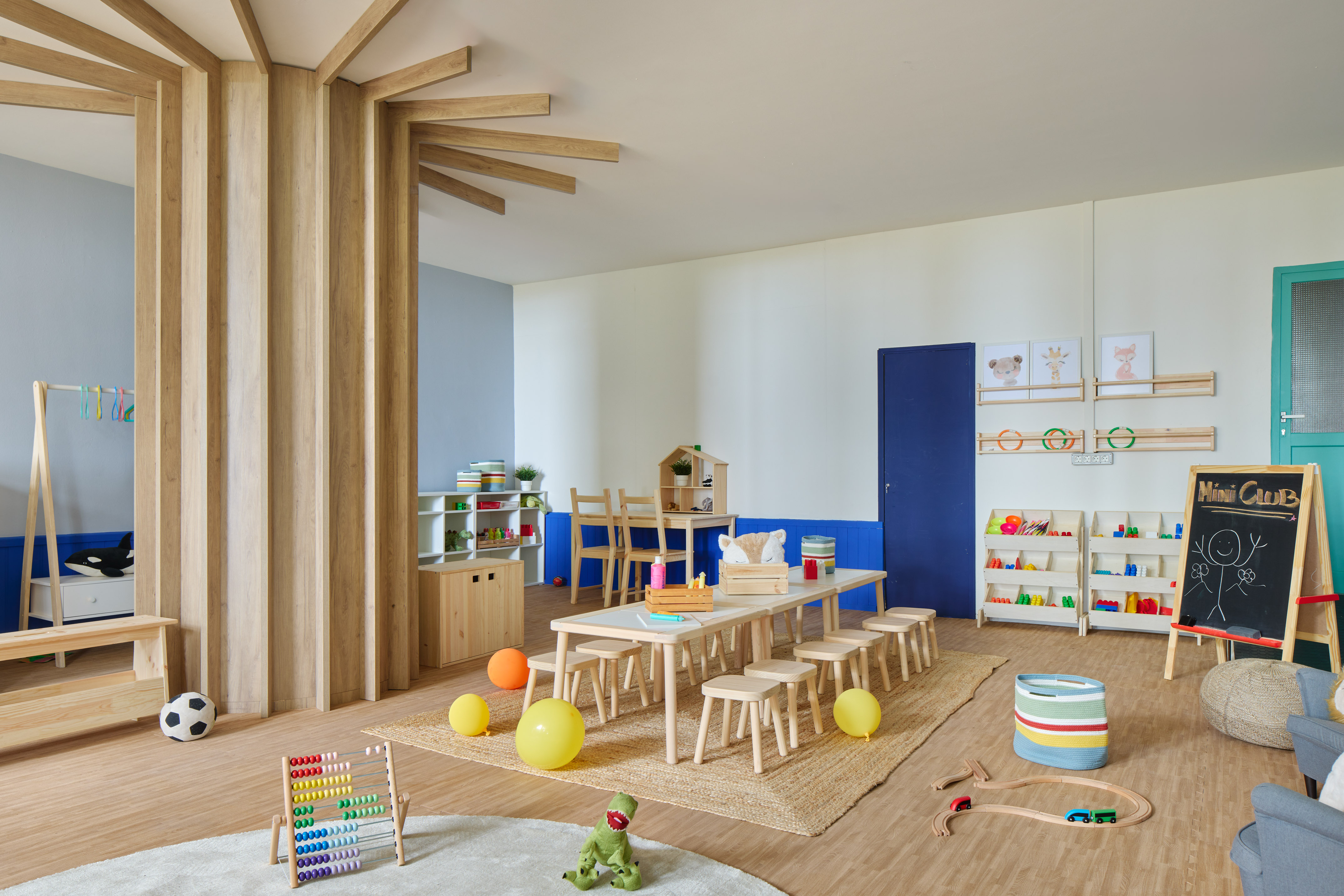 Children's playroom with natural wood furniture, colorful toys, and abacus.