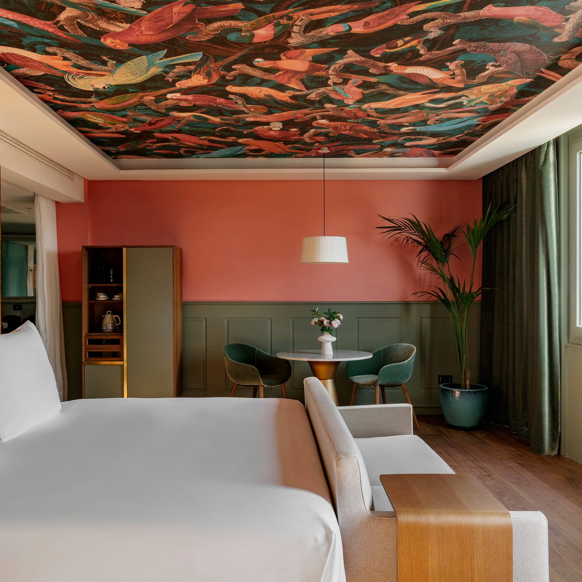 a room with a bed and a table and chairs