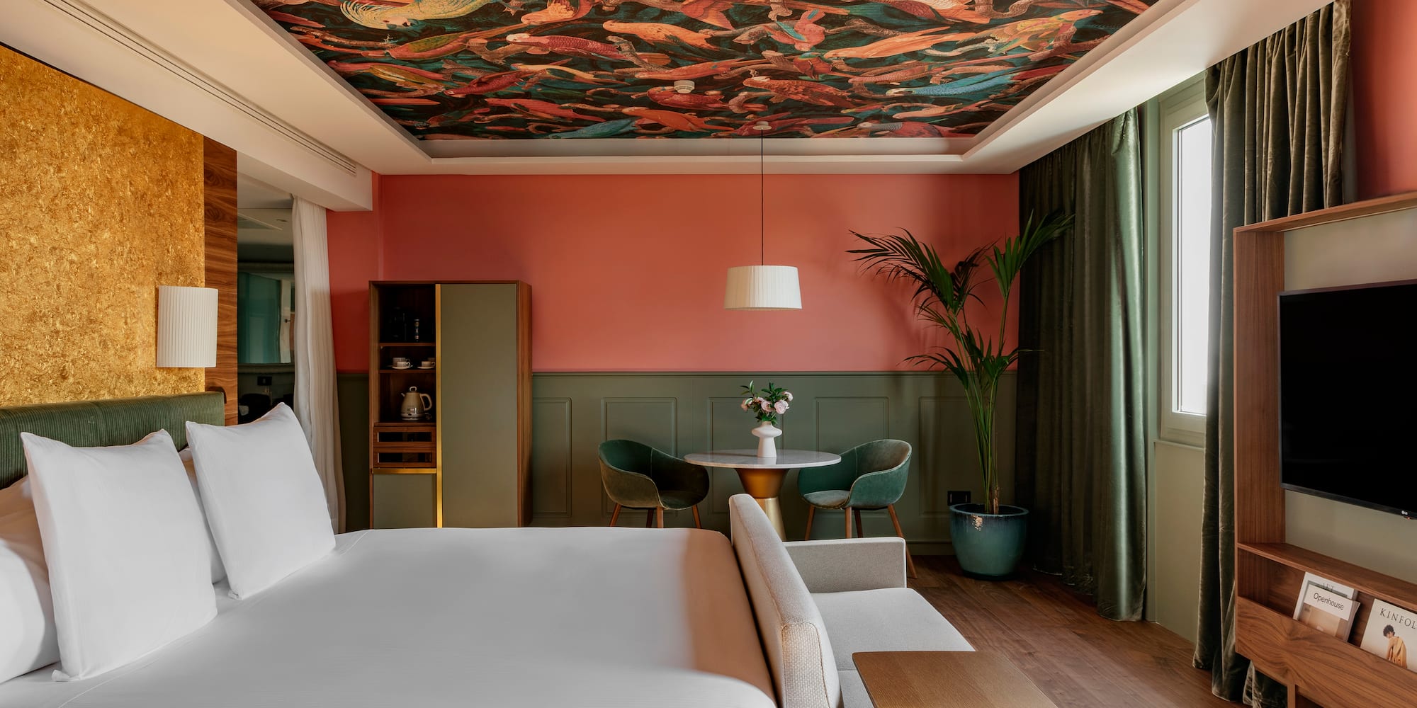 a room with a bed and a table and chairs