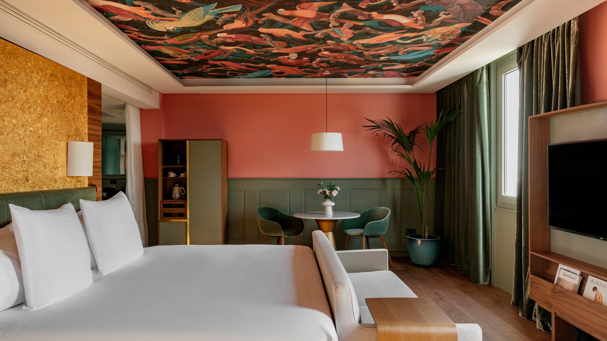 a room with a bed and a table and chairs