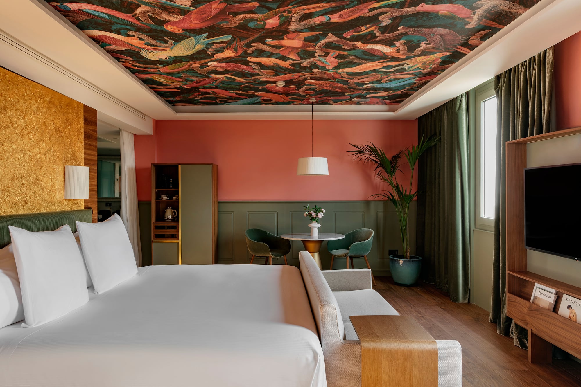 a room with a bed and a table and chairs