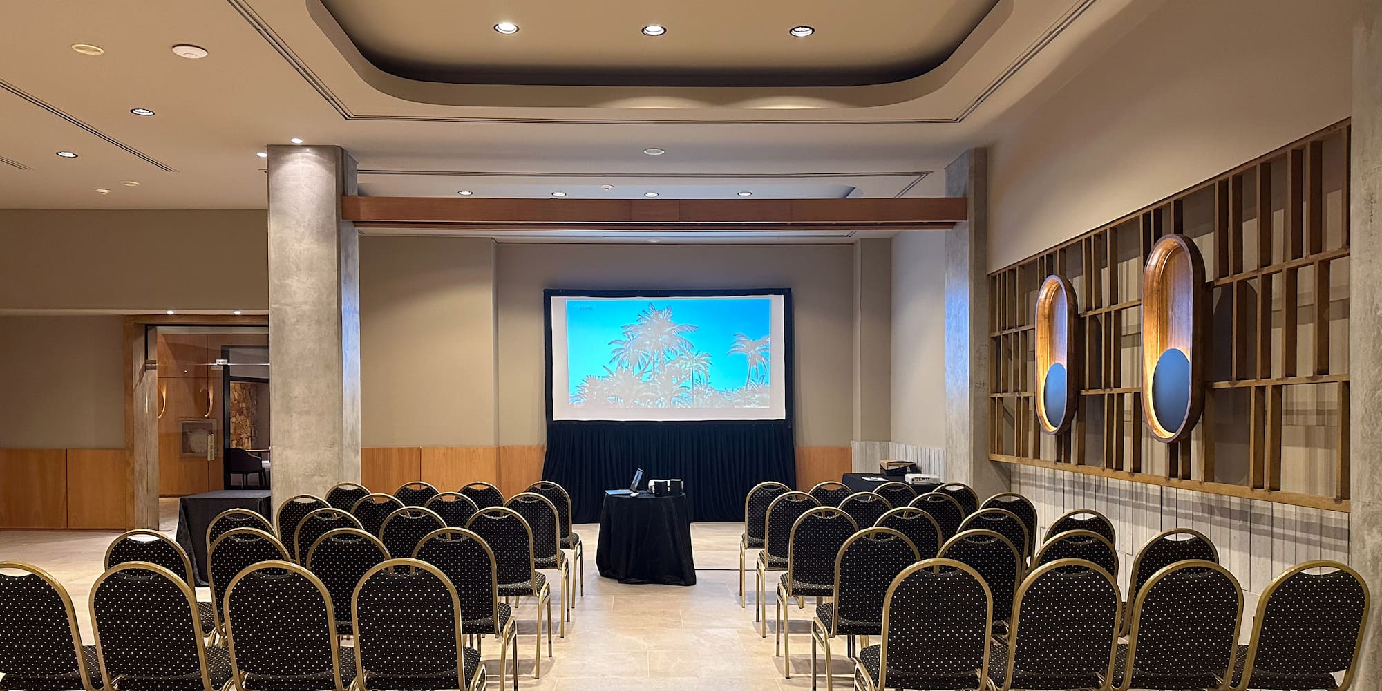 a room with chairs and a projector screen