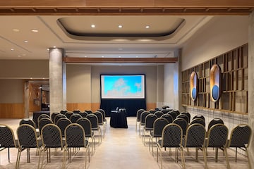 a room with chairs and a projector screen