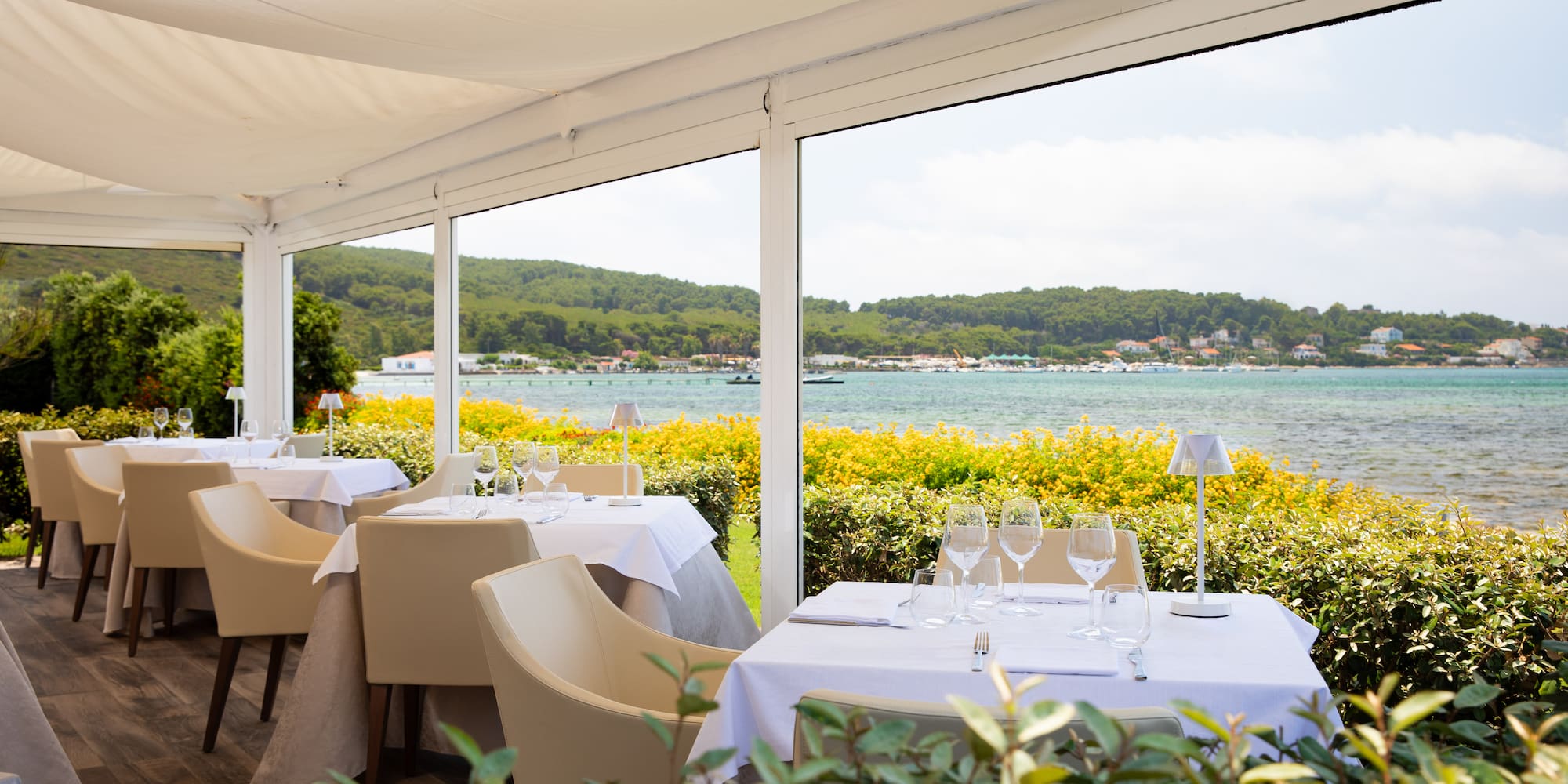 a table set up with chairs and glasses on it