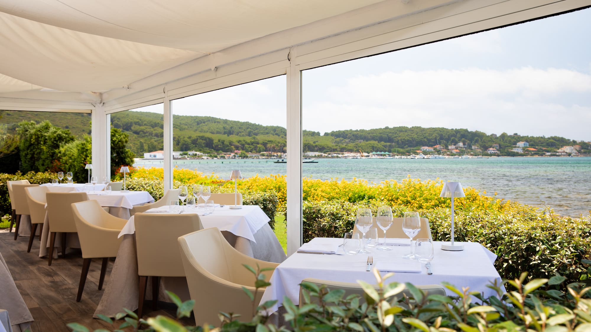 a table set up with chairs and glasses on it