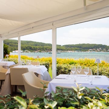 a table set up with chairs and glasses on it
