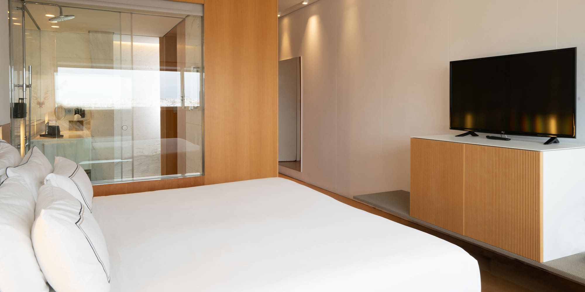 a room with a bed and a television