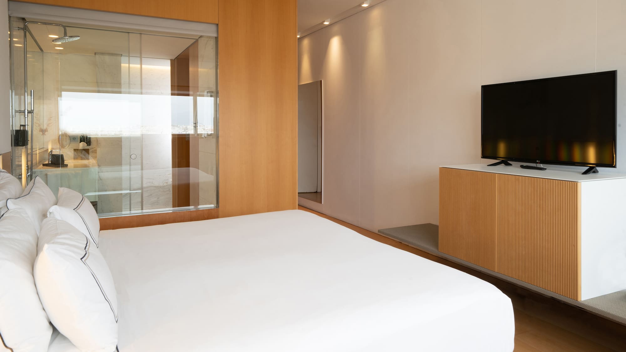 a room with a bed and a television