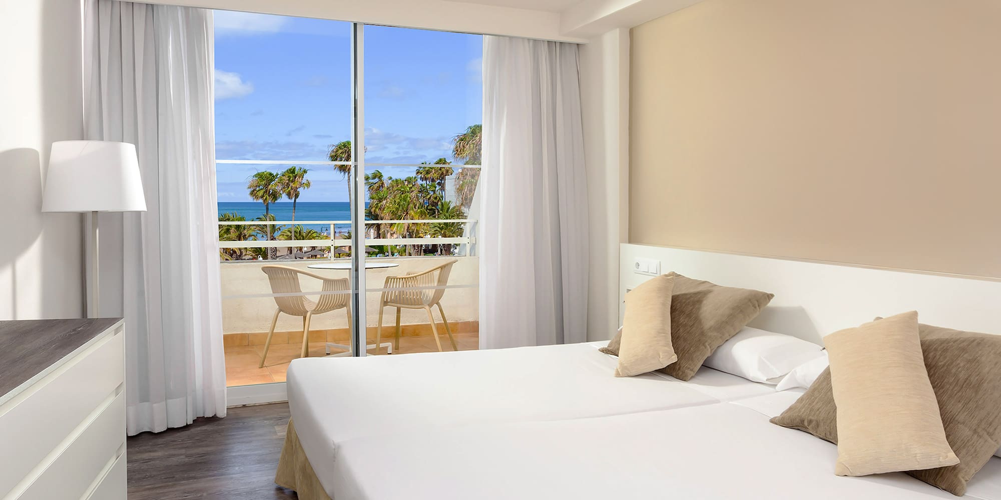 a hotel room with a view of the ocean and a balcony