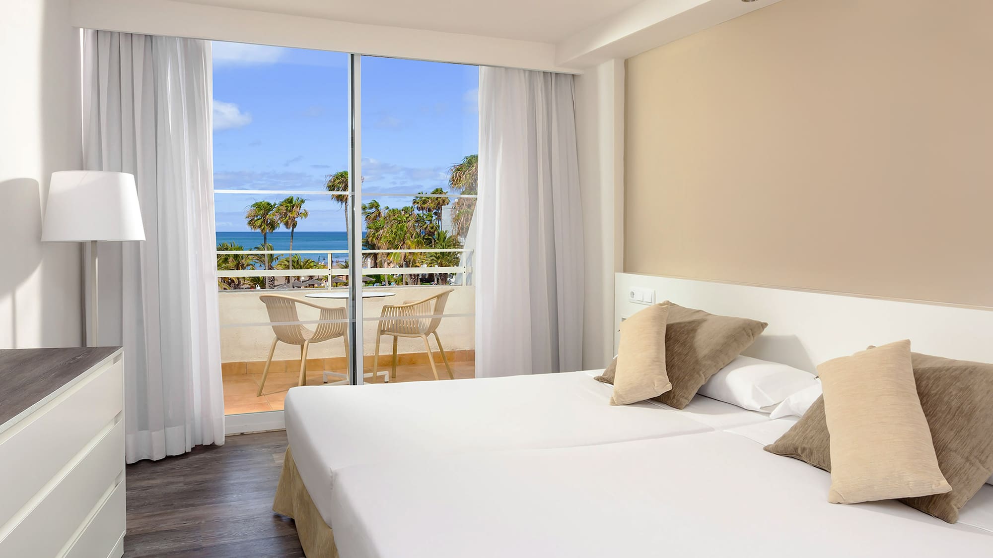 a hotel room with a view of the ocean and a balcony