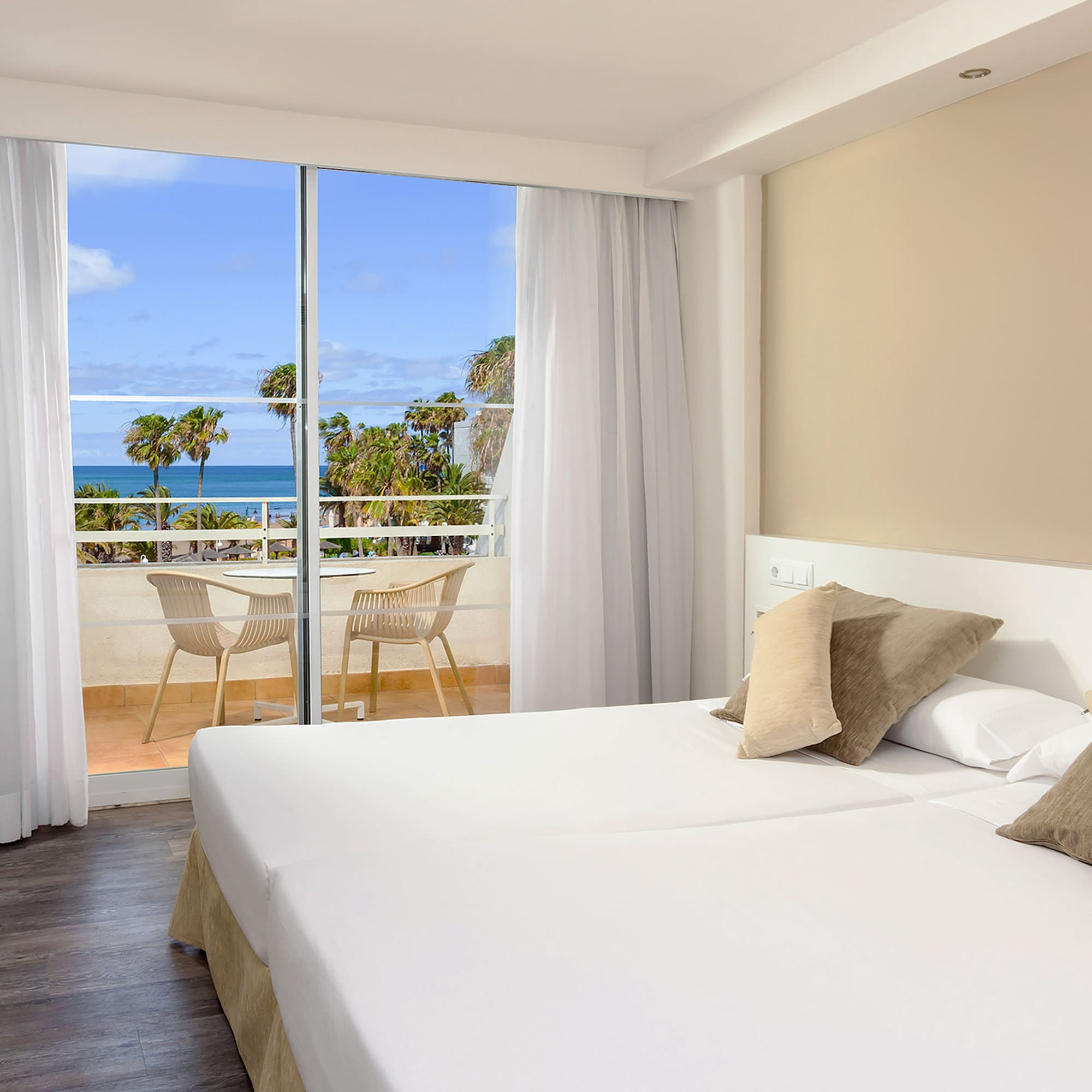 a hotel room with a view of the ocean and a balcony