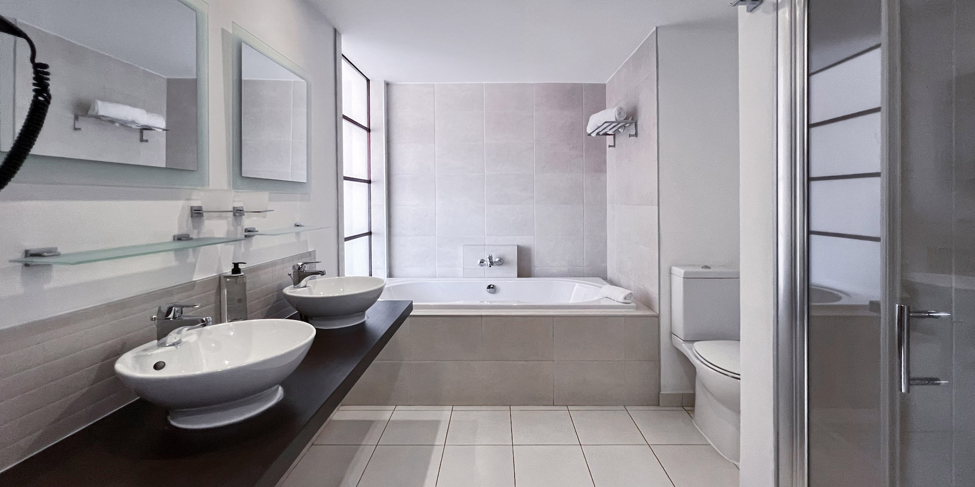 a bathroom with a tub and sinks