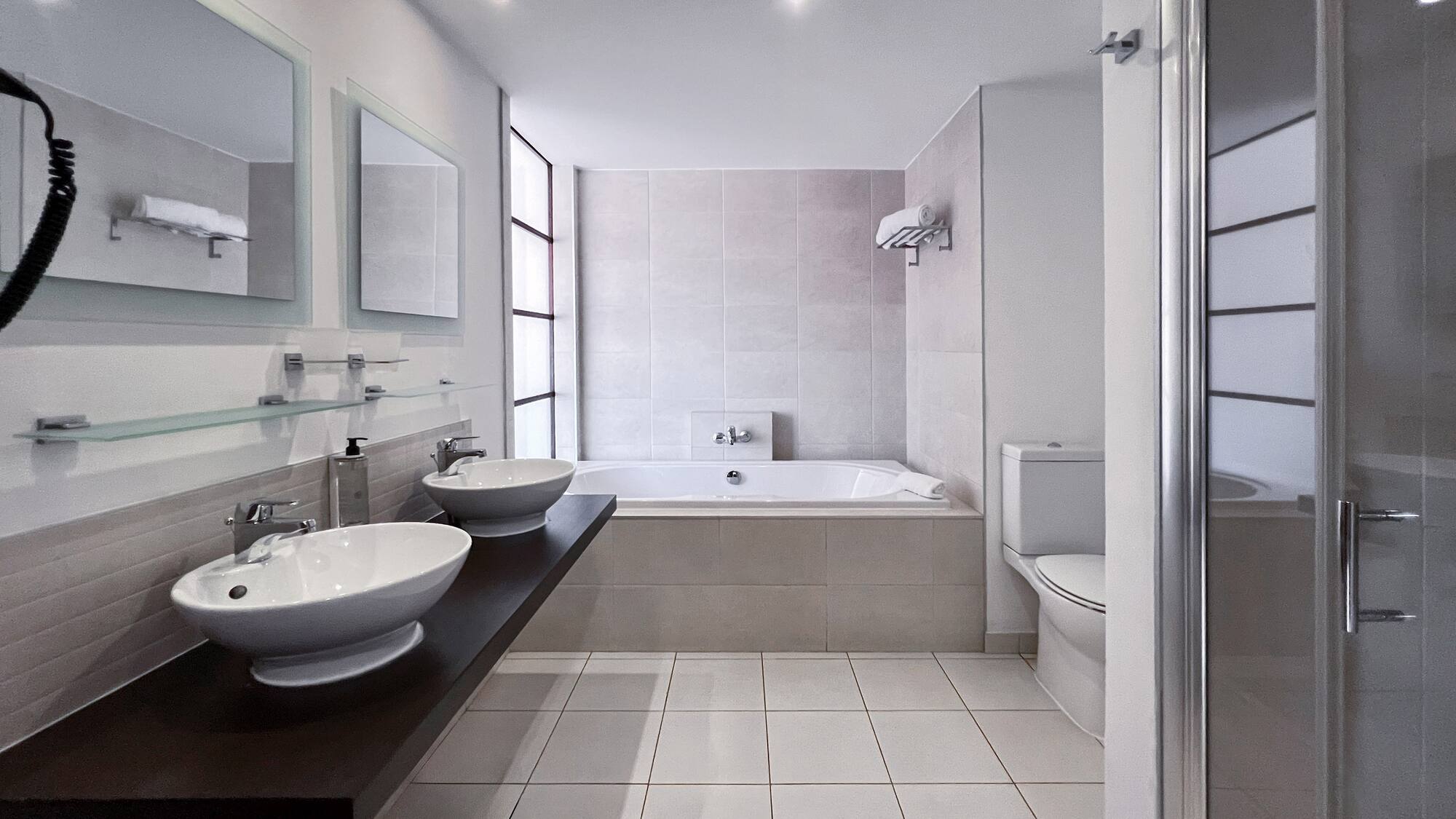 a bathroom with a tub and sinks