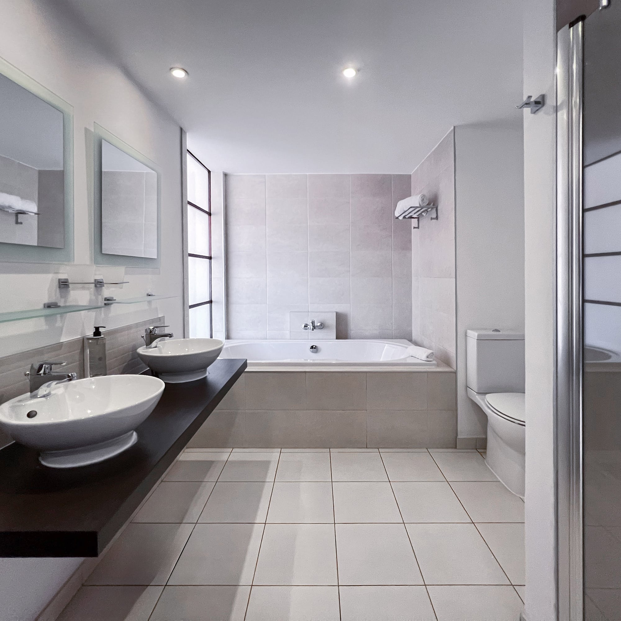 a bathroom with a tub and sinks