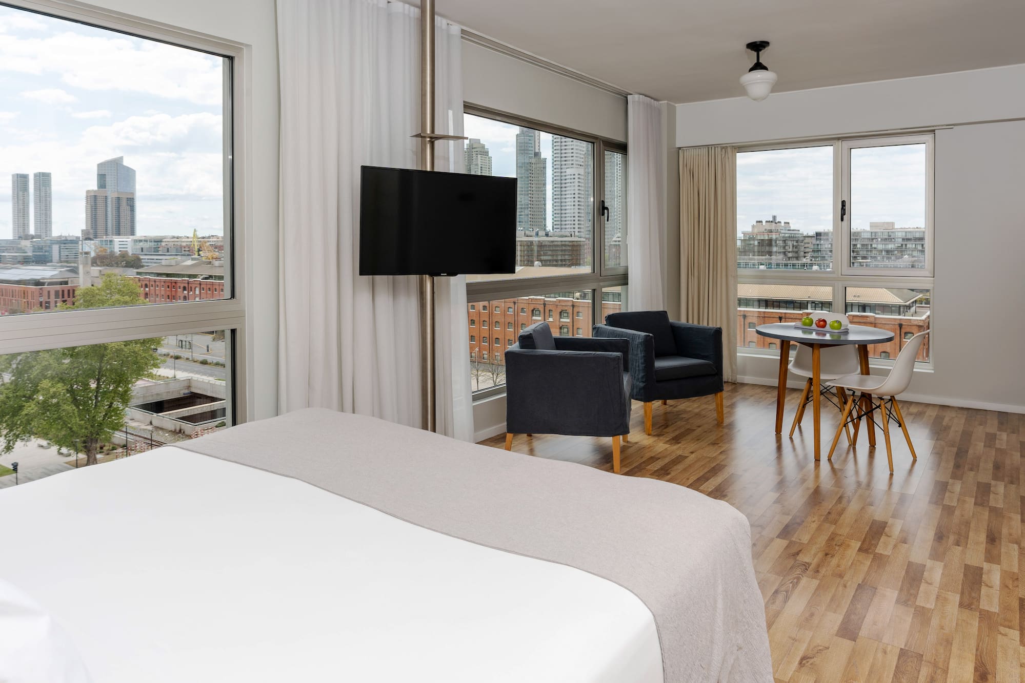 a room with a bed and chairs and a table