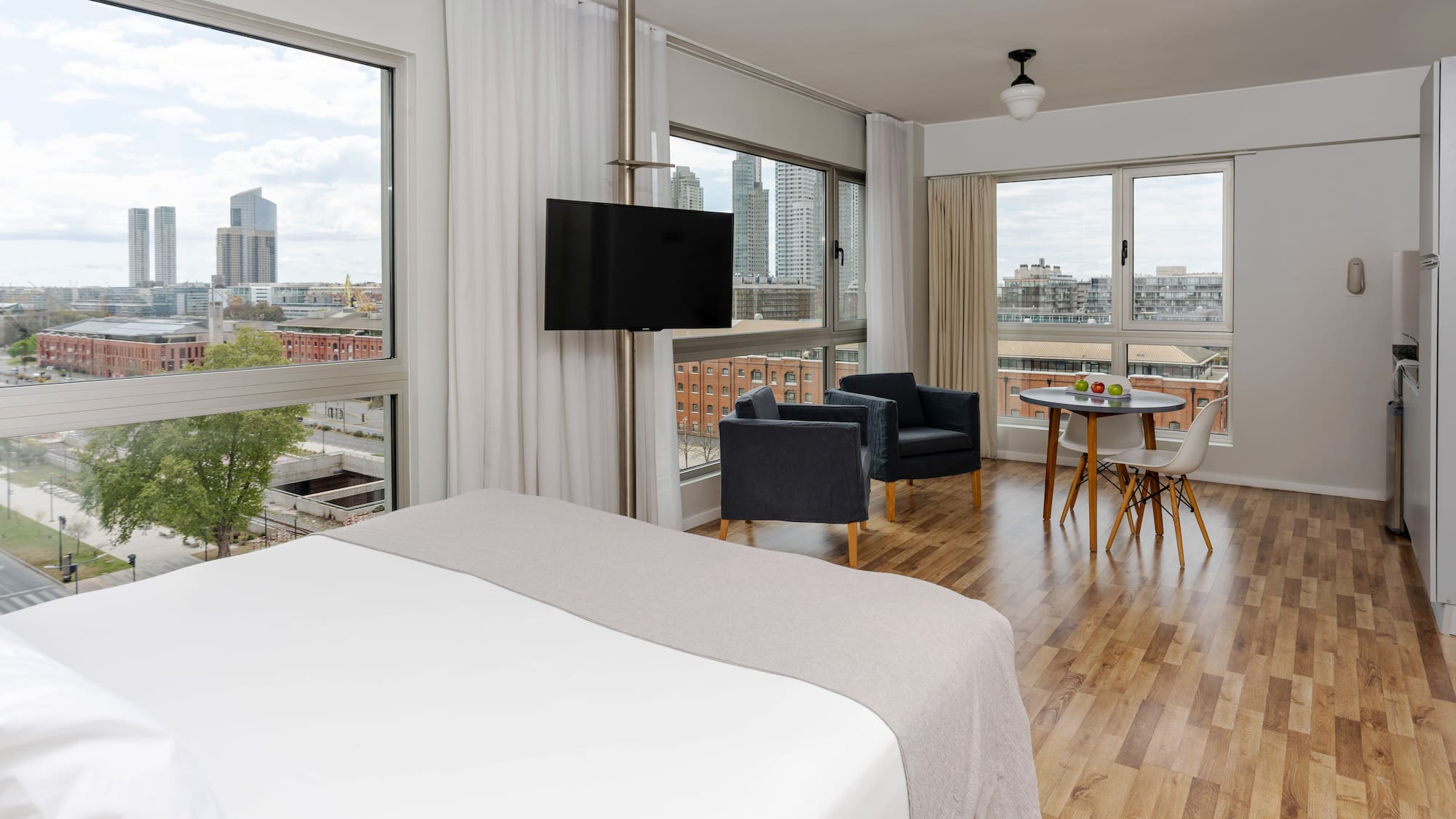 a room with a bed and chairs and a table
