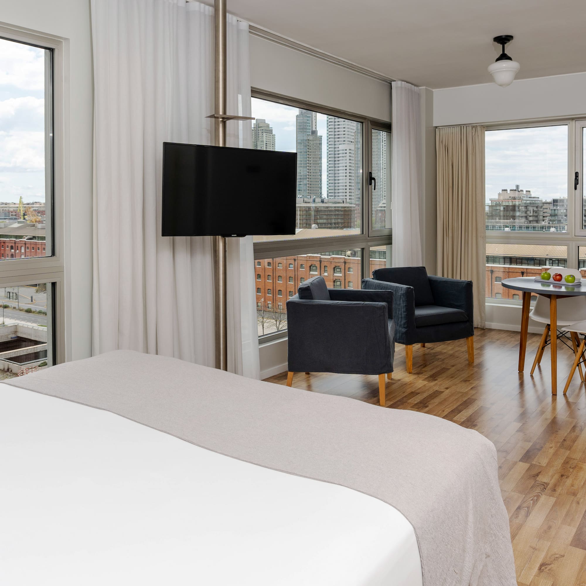 a room with a bed and chairs and a table