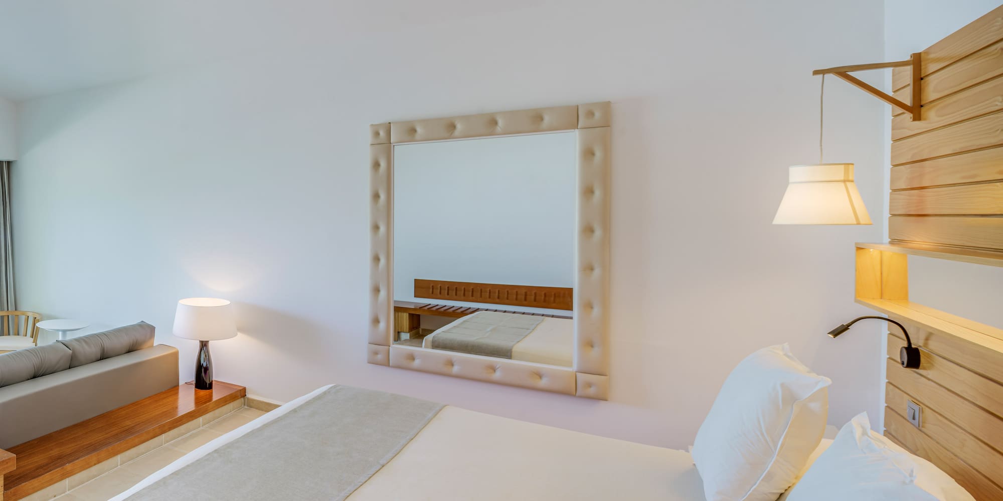 a mirror above a bed