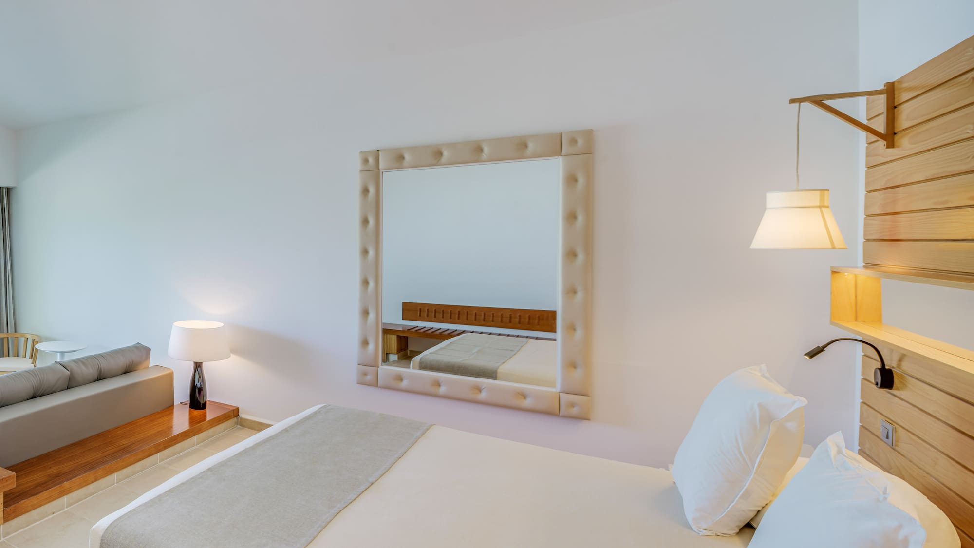 a mirror above a bed