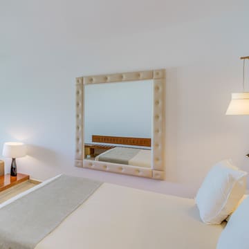 a mirror above a bed