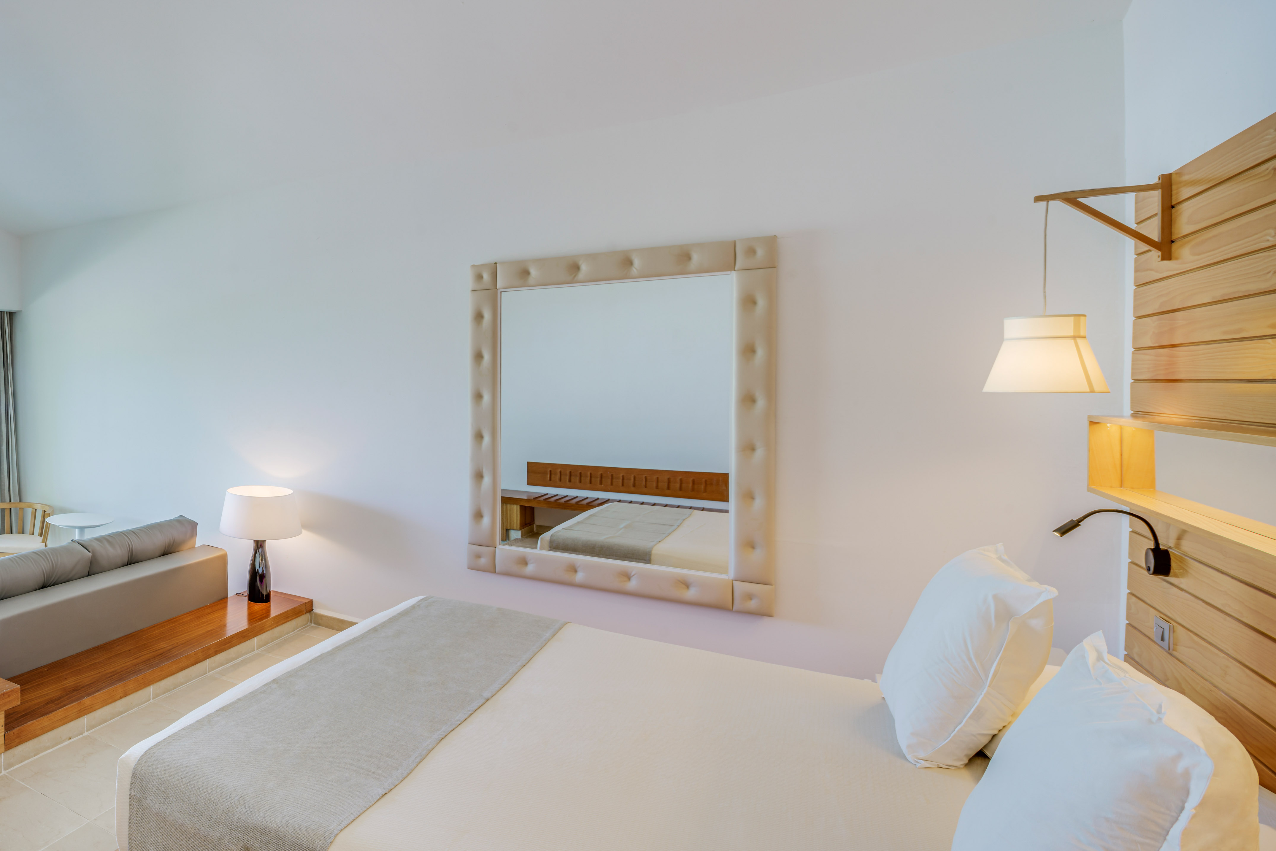 a mirror above a bed