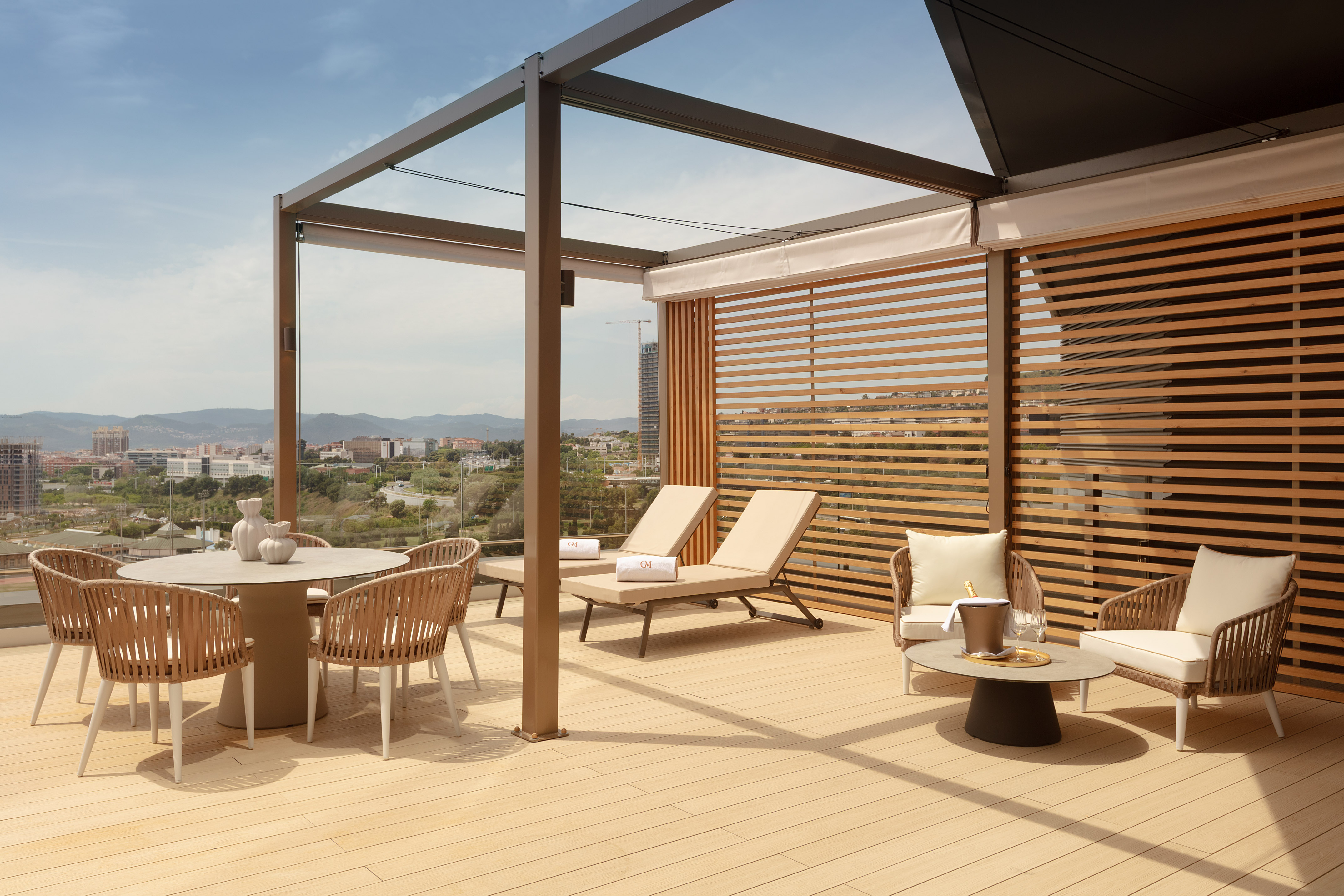 Luxury hotel terrace with modern furniture, pergola, and cityscape view.