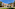 a building with trees and grass