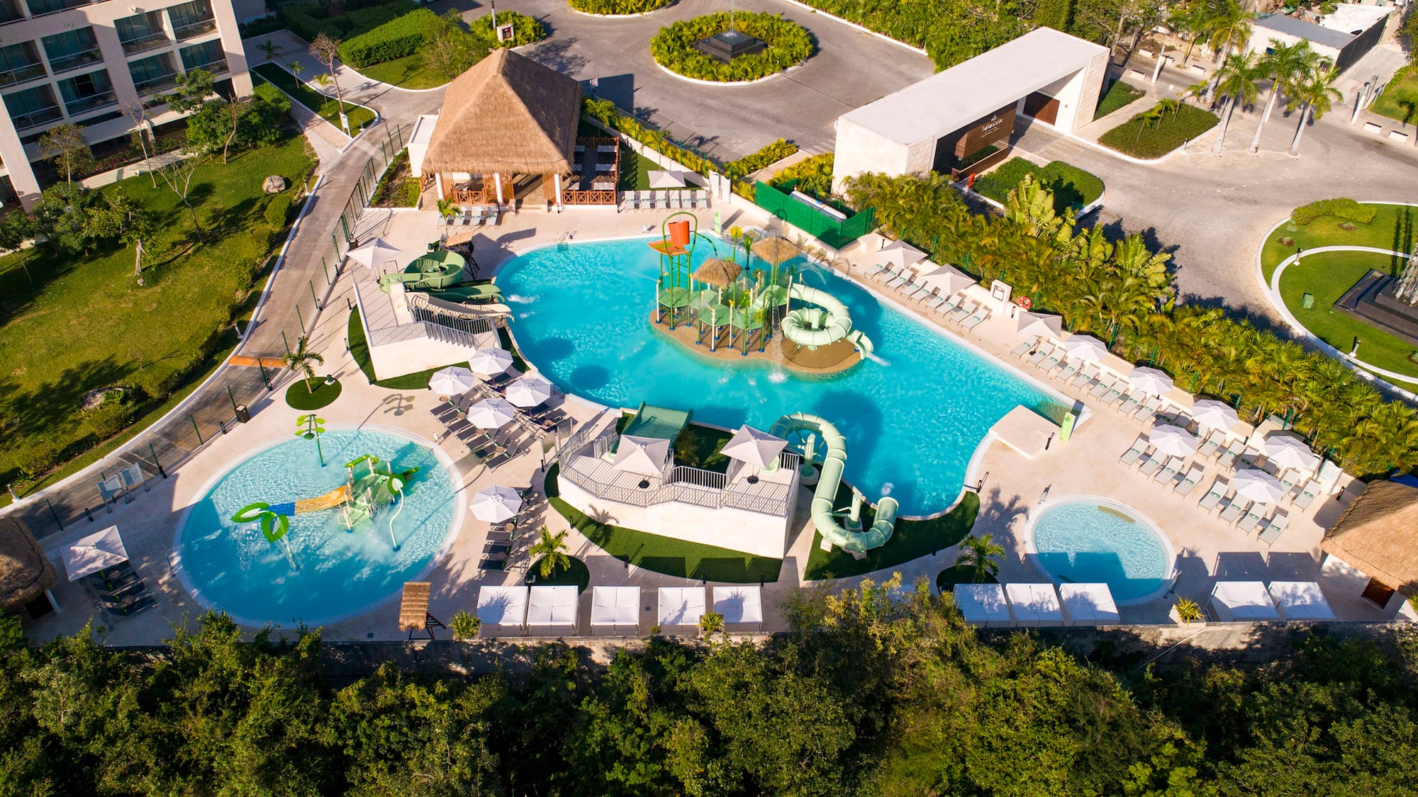 Luxury resort water park with multiple pools, slides, and hotel buildings.