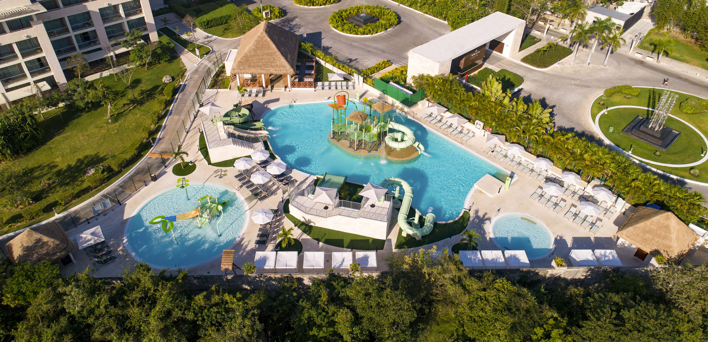Luxury resort water park with multiple pools, slides, and hotel buildings.