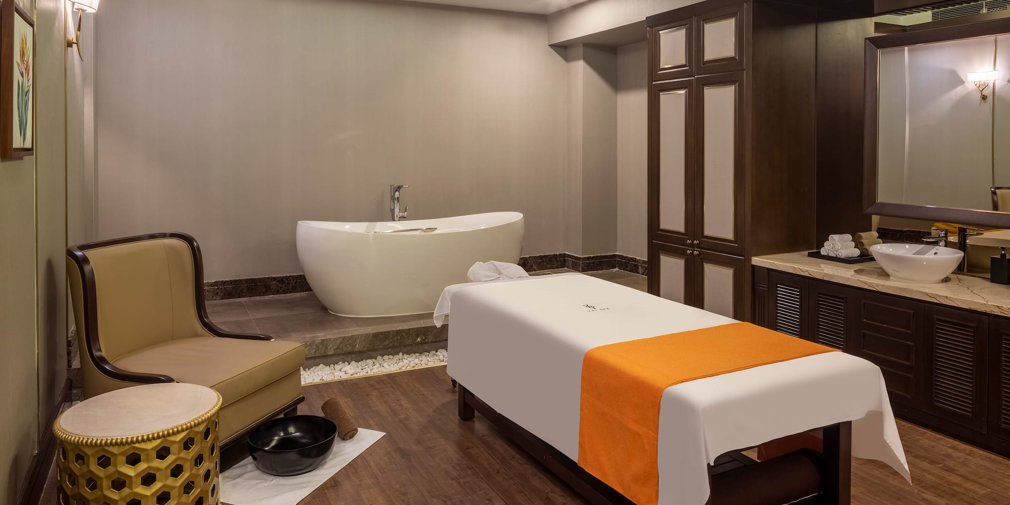 uma sala com uma mesa de massagem e uma banheira