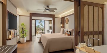 a bedroom with a television and a bathtub