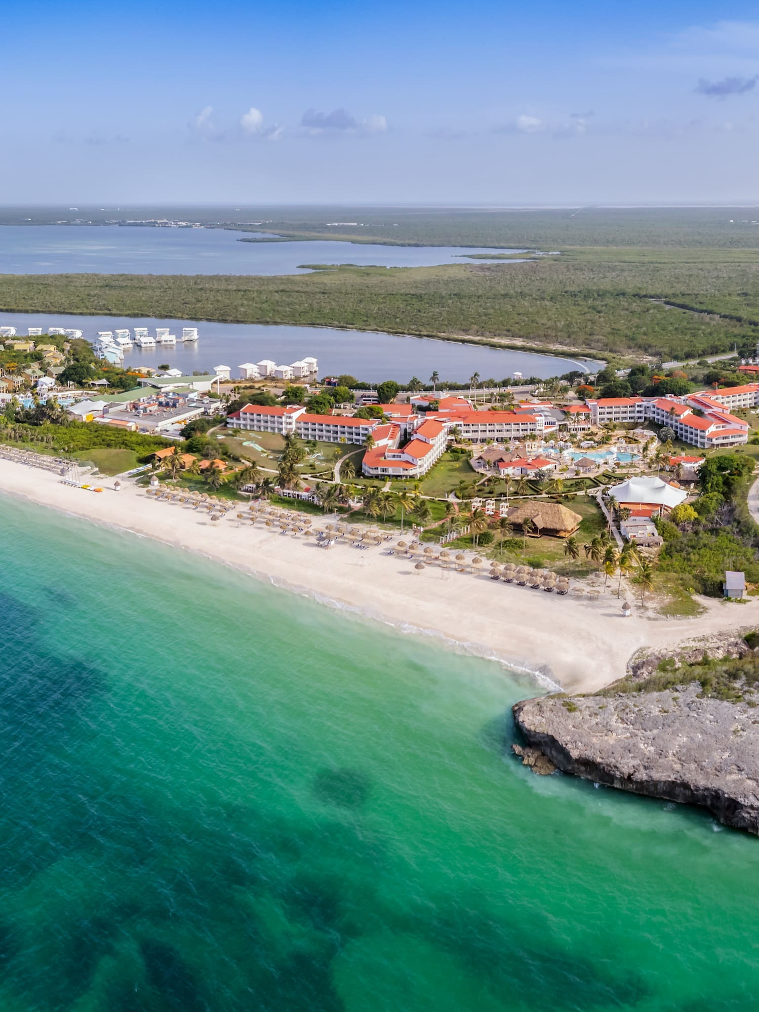 a beach with buildings and a body of water